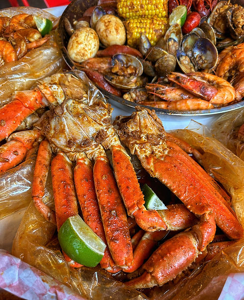 Delicious seafood platter with crab legs, corn, and lemon wedges. Grab A Crab